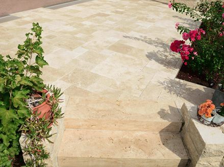 Kundenfoto: Travertin-Platten Medium, getrommelt, römischer Verband, verlegt auf Terrasse, Aufnahme der Treppenstufen mit Blumenbeeten link und rechts